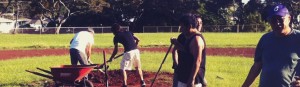 Mel Choy supervising the team as they work on the fields.